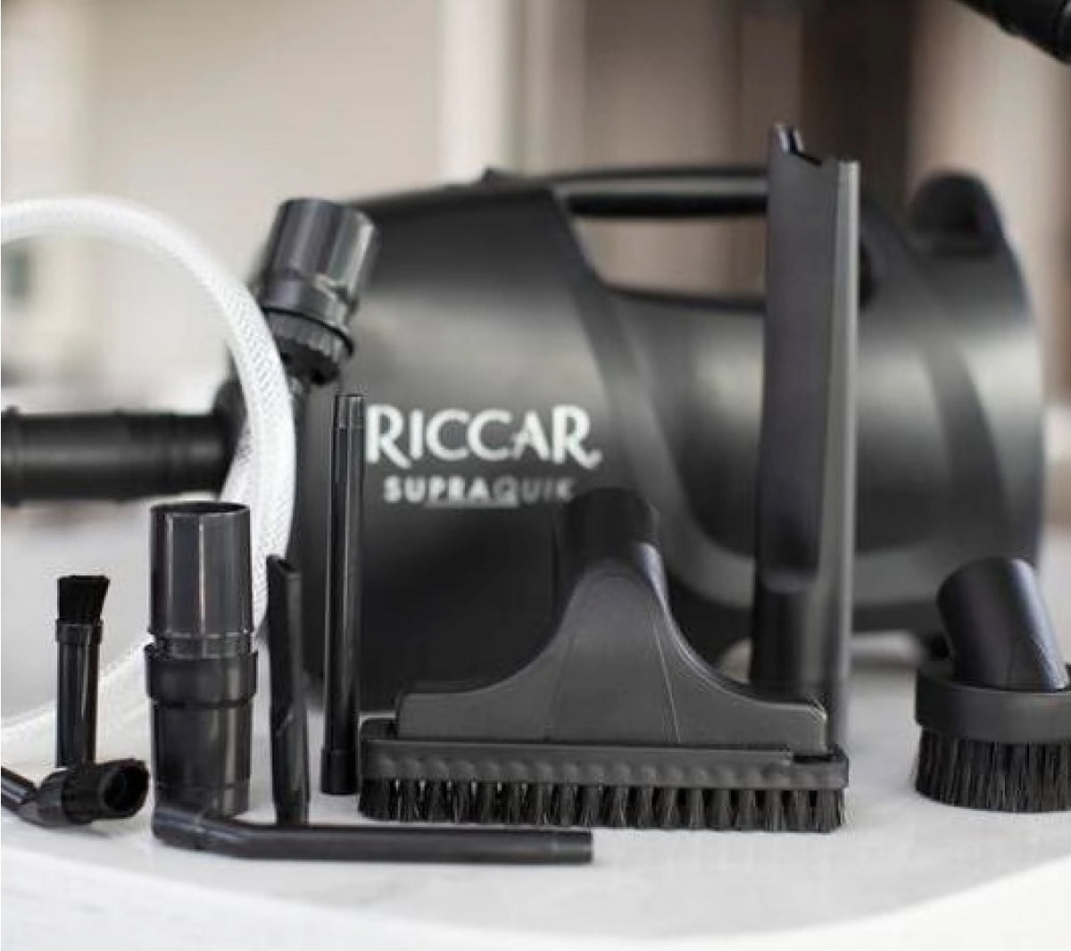 Riccar SupraQuik with its included crevice tool, dusting brush, upholstery brush and micro tool set