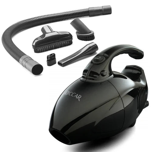 Riccar Gem GEM-R.6 black handheld vacuum shown with its flexible hose, upholstery brush, dusting brush, and crevice tool
